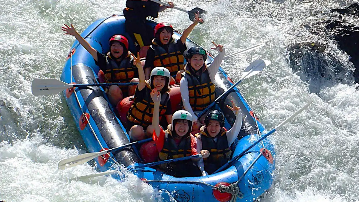 Rafters paddling through whitewater rapids on a Hozugawa river rafting adventure near Arashiyama Kyoto